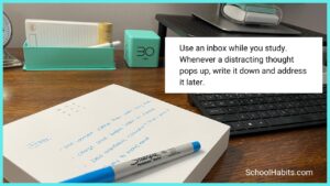 A desk with an inbox and the text: use an inbox while you study. whenever a distracting thought pops up, write it down and address it later.